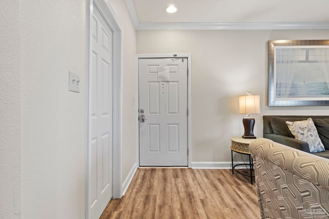 foyer entrance with recessed lighting, wood finished floors, baseboards, and ornamental molding