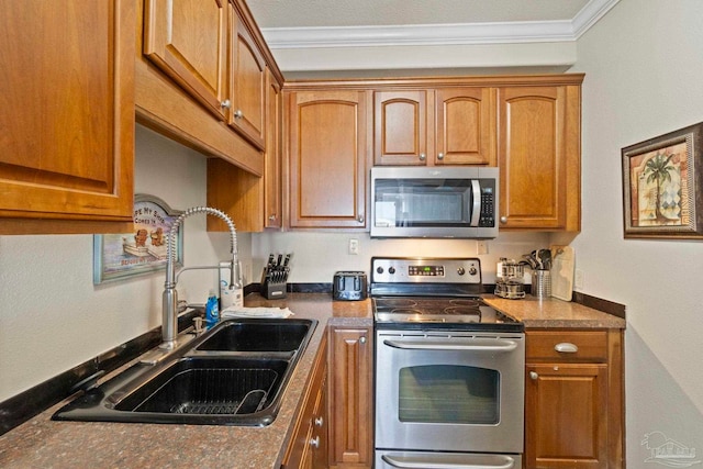 kitchen featuring a sink, stainless steel appliances, dark countertops, and ornamental molding