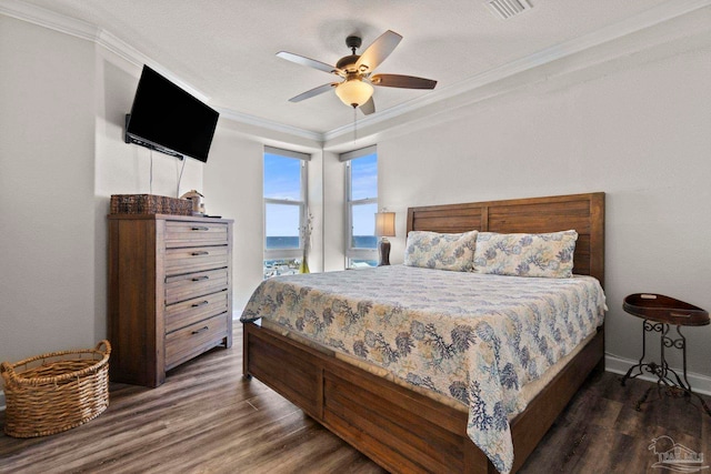 bedroom featuring visible vents, baseboards, ceiling fan, dark wood finished floors, and ornamental molding