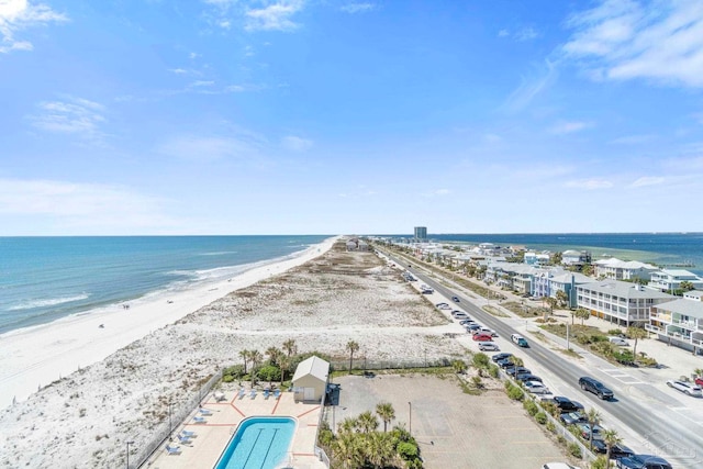 aerial view with a water view and a beach view