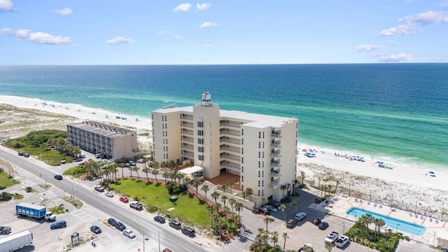 birds eye view of property featuring a beach view and a water view