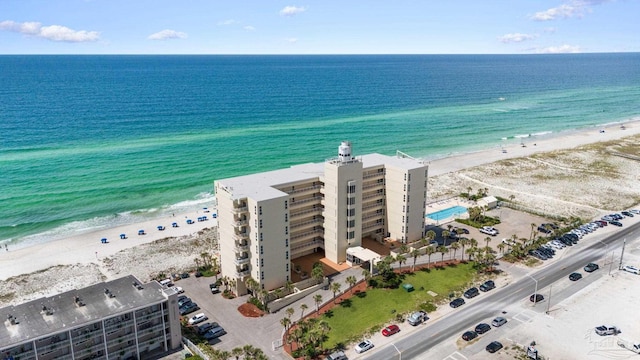 drone / aerial view featuring a beach view and a water view