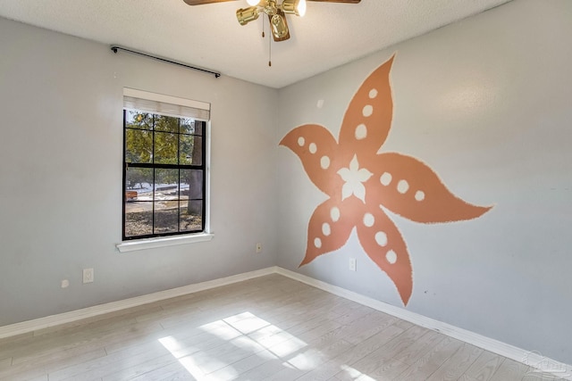 unfurnished room with light hardwood / wood-style flooring, a textured ceiling, plenty of natural light, and ceiling fan