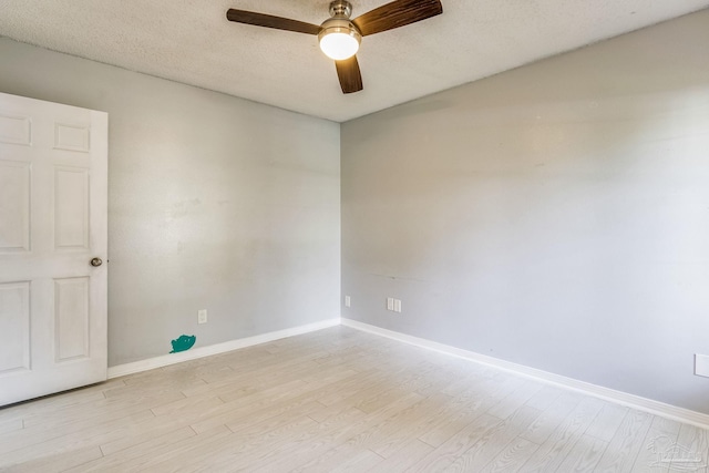 spare room featuring ceiling fan and light hardwood / wood-style flooring