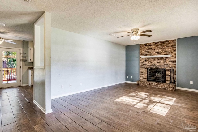 unfurnished living room with a textured ceiling, a fireplace, and ceiling fan