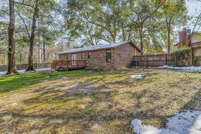 view of yard featuring a wooden deck and central air condition unit