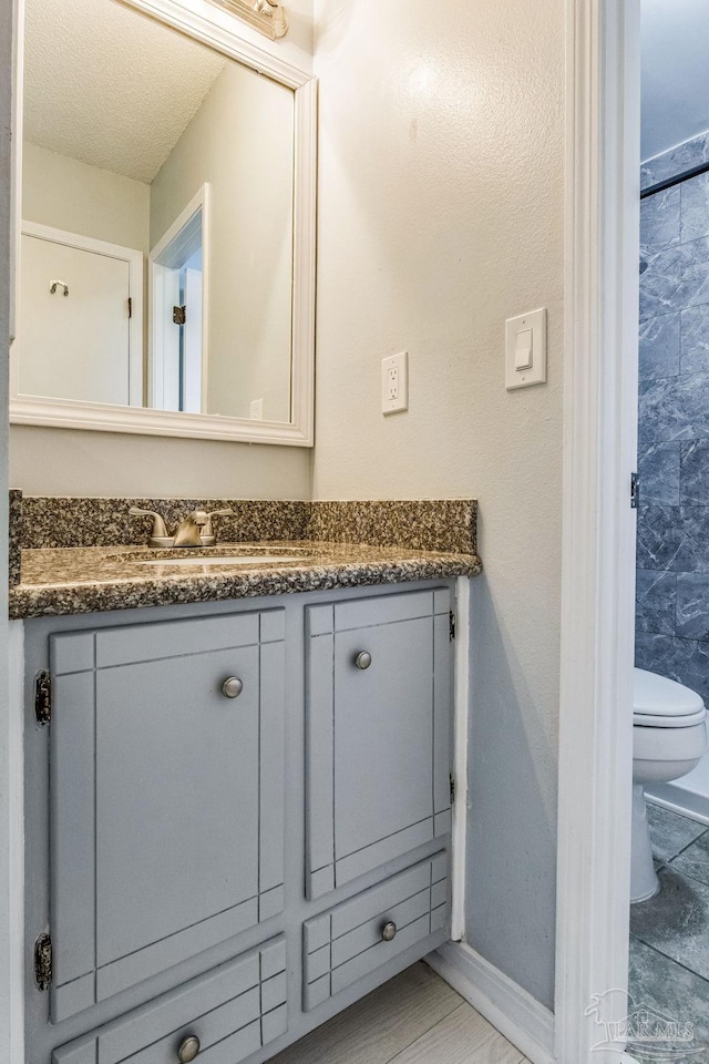 bathroom featuring vanity and toilet