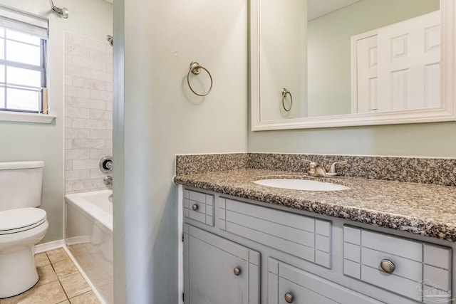 full bathroom with vanity, tiled shower / bath combo, tile patterned floors, and toilet