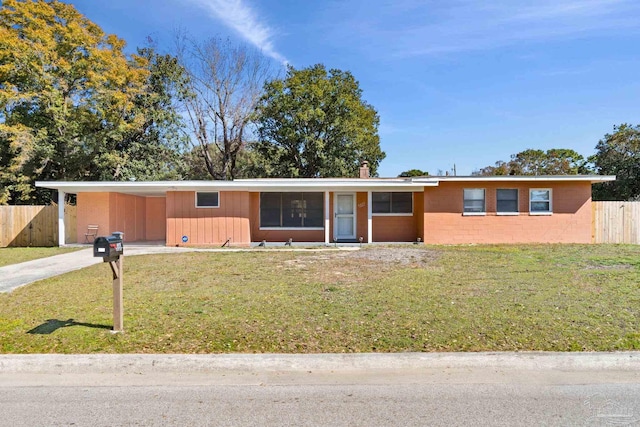 ranch-style home with a front yard and a carport