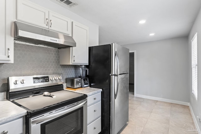 kitchen with white cabinetry, appliances with stainless steel finishes, decorative backsplash, and light tile patterned floors