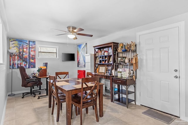 dining space with light tile patterned floors and ceiling fan