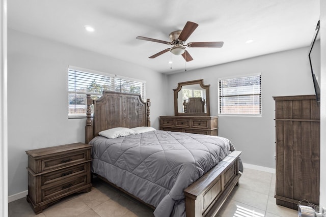 tiled bedroom featuring ceiling fan