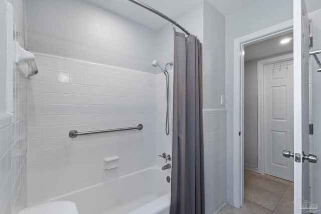 bathroom featuring tile patterned flooring and shower / bath combo