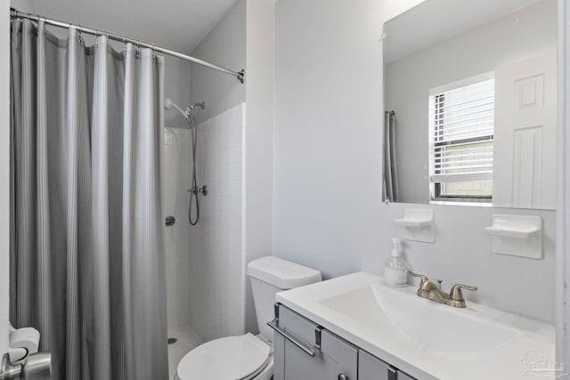 bathroom with vanity, a shower with curtain, and toilet