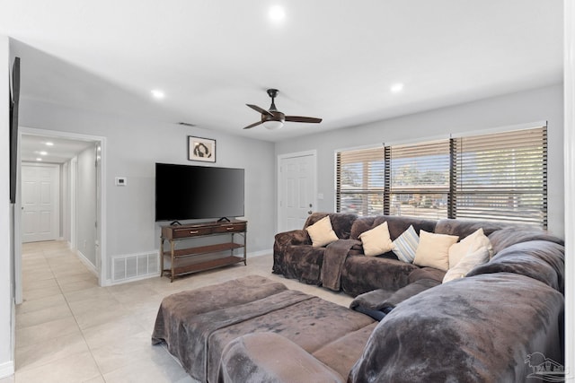 tiled living room with ceiling fan