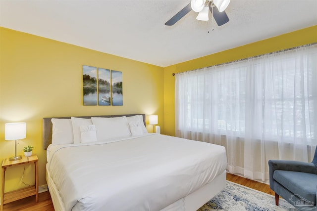 bedroom with ceiling fan and light hardwood / wood-style floors