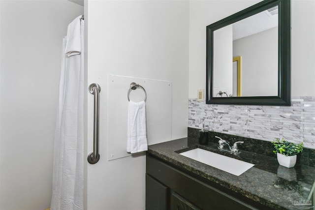 bathroom featuring vanity and backsplash