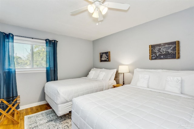 bedroom with ceiling fan and light hardwood / wood-style floors