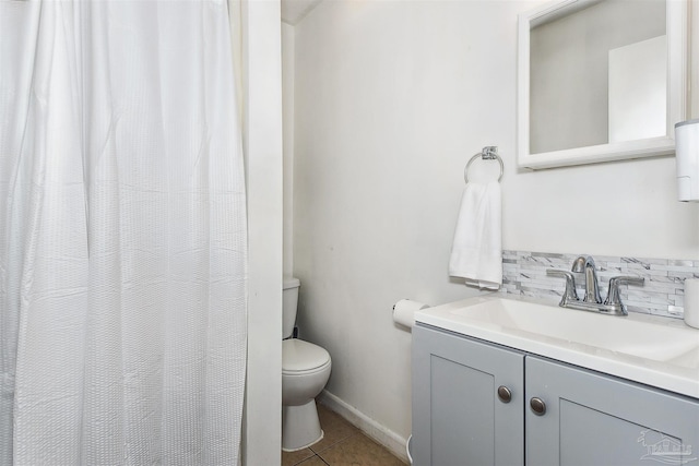 bathroom featuring vanity, toilet, and tile patterned flooring