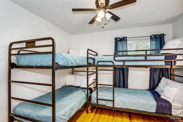 bedroom with ceiling fan and wood-type flooring