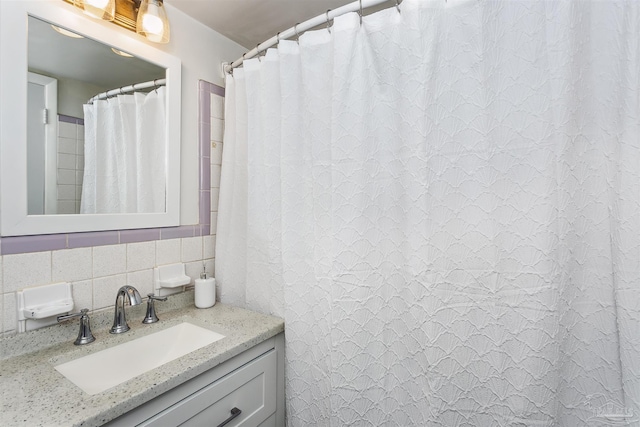 bathroom with vanity, tasteful backsplash, a shower with curtain, and tile walls