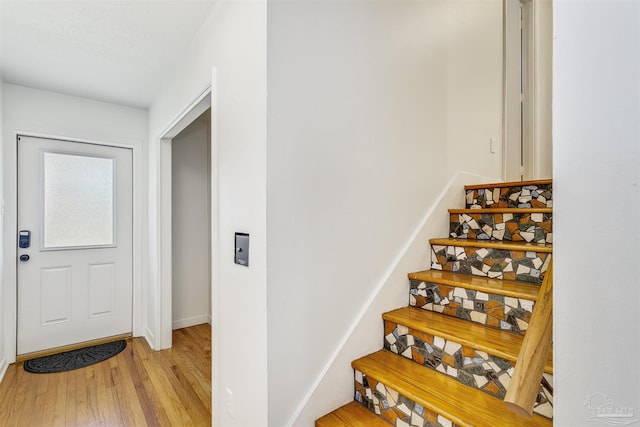 stairway featuring hardwood / wood-style floors