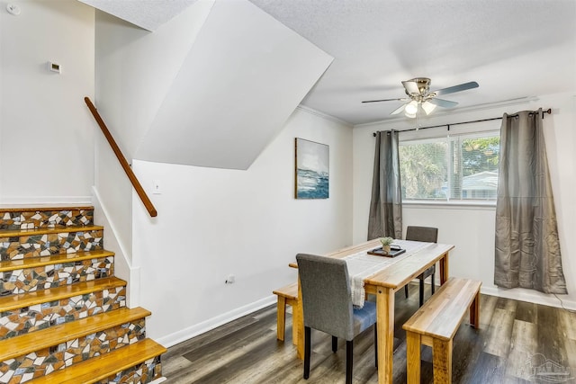 dining area with dark wood-type flooring, ceiling fan, crown molding, and a textured ceiling