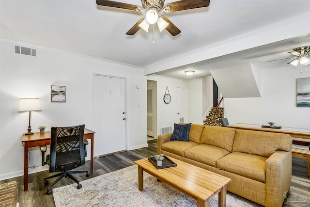 living room with dark wood-type flooring, ceiling fan, and crown molding