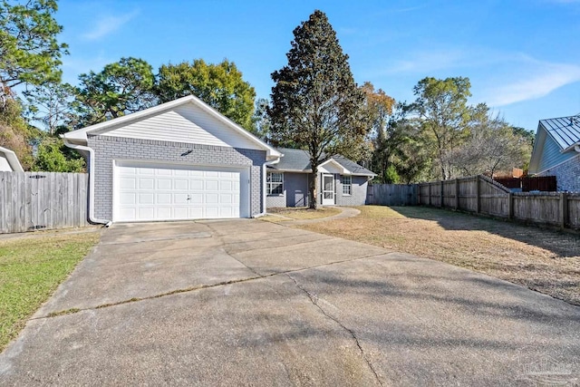 single story home featuring a front yard and a garage