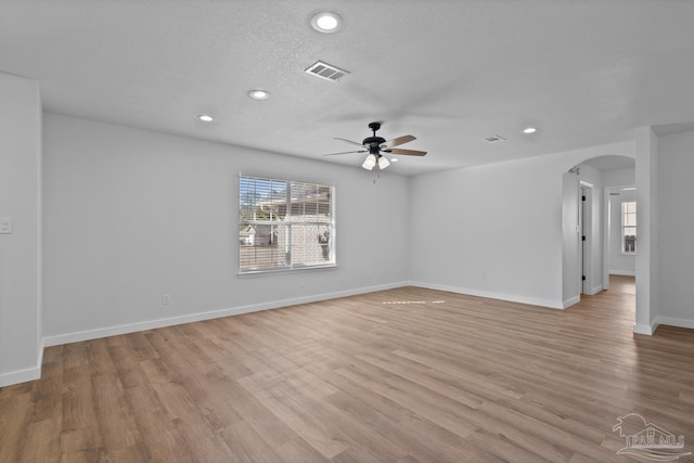 unfurnished room featuring ceiling fan, a textured ceiling, and light hardwood / wood-style flooring