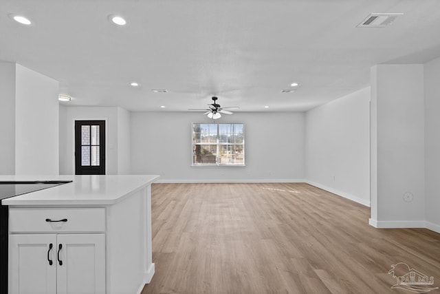 unfurnished living room featuring ceiling fan and light wood-type flooring