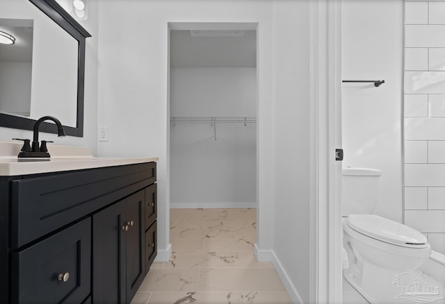 bathroom featuring toilet and vanity