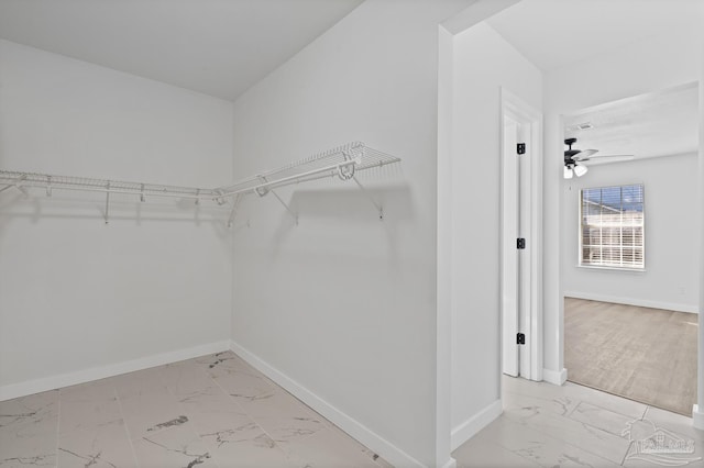 walk in closet featuring ceiling fan