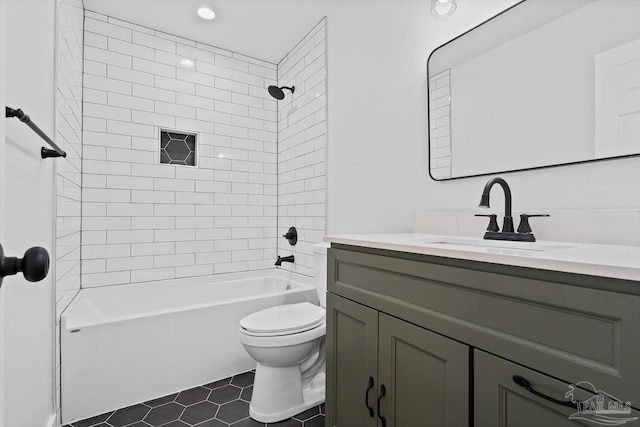 full bathroom featuring tile patterned floors, tiled shower / bath combo, toilet, and vanity