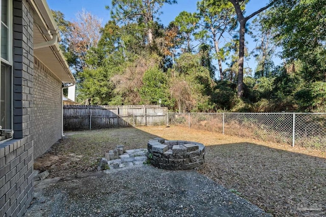 view of yard with a fire pit