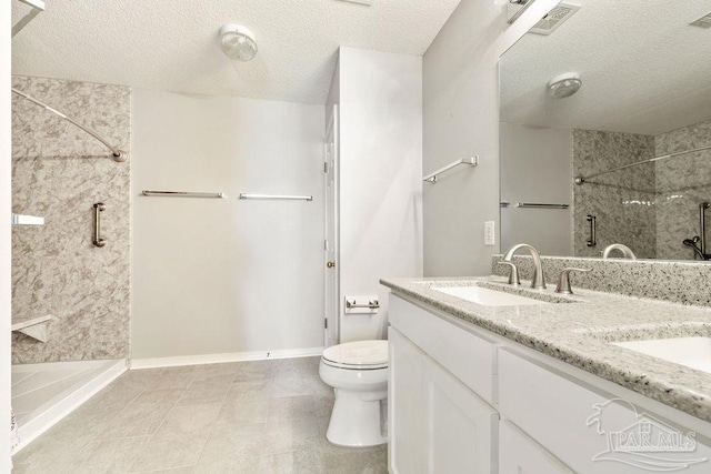 bathroom featuring visible vents, double vanity, a sink, a shower, and toilet