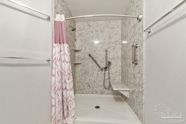 full bathroom featuring a shower with curtain and a textured ceiling