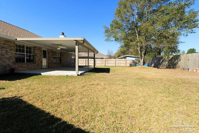 view of yard featuring a patio, a fenced backyard, and a ceiling fan