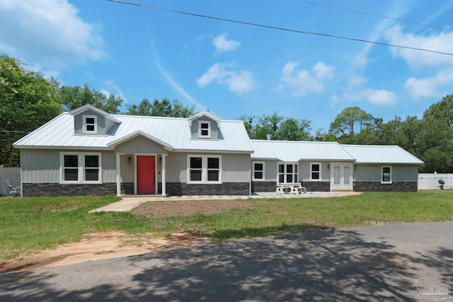 4881 Calvin Dr, Milton, FL 32583 - view of front of property with french doors, stone siding, metal roof, and a standing seam roof