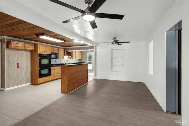 4881 Calvin Dr, Milton, FL 32583 - kitchen featuring black appliances, a sink, dark countertops, open floor plan, and ceiling fan