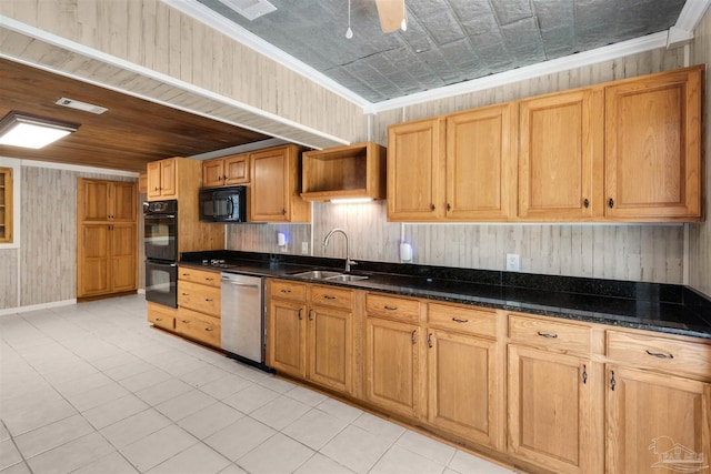 4881 Calvin Dr, Milton, FL 32583 - kitchen with black appliances, a sink, wood walls, dark stone counters, and light tile patterned flooring