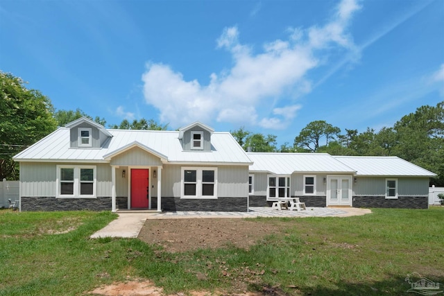 4881 Calvin Dr, Milton, FL 32583 - view of front of property with french doors, a front lawn, metal roof, and stone siding