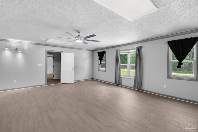 4881 Calvin Dr, Milton, FL 32583 - spare room featuring a textured ceiling, wood finished floors, ceiling fan, and ornamental molding