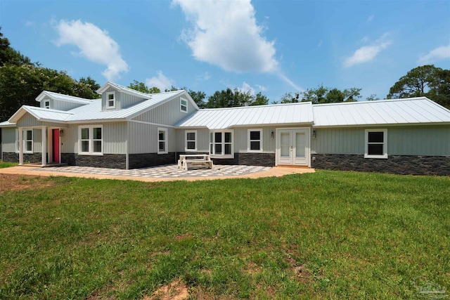 4881 Calvin Dr, Milton, FL 32583 - rear view of property featuring stone siding, french doors, a patio, and metal roof