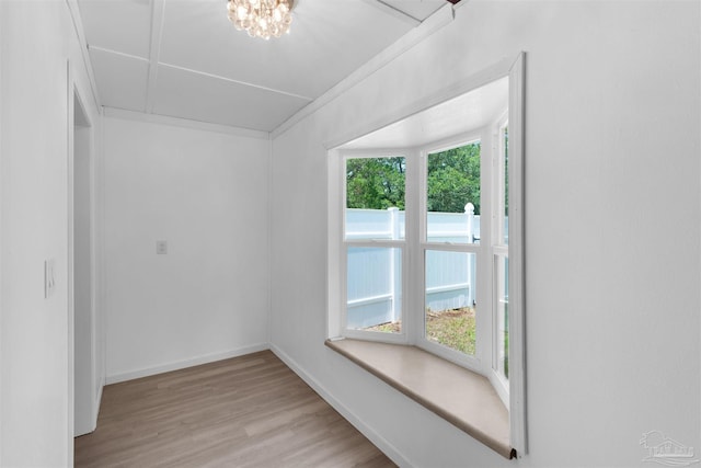 4881 Calvin Dr, Milton, FL 32583 - empty room with wood finished floors, baseboards, and a chandelier