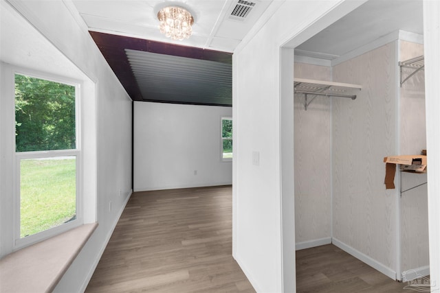 4881 Calvin Dr, Milton, FL 32583 - additional living space featuring wood finished floors, a chandelier, and baseboards