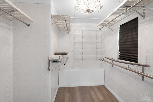 4881 Calvin Dr, Milton, FL 32583 - walk in closet featuring wood finished floors and a chandelier