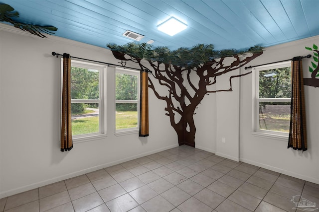 4881 Calvin Dr, Milton, FL 32583 - spare room with healthy amount of natural light, light tile patterned floors, and baseboards