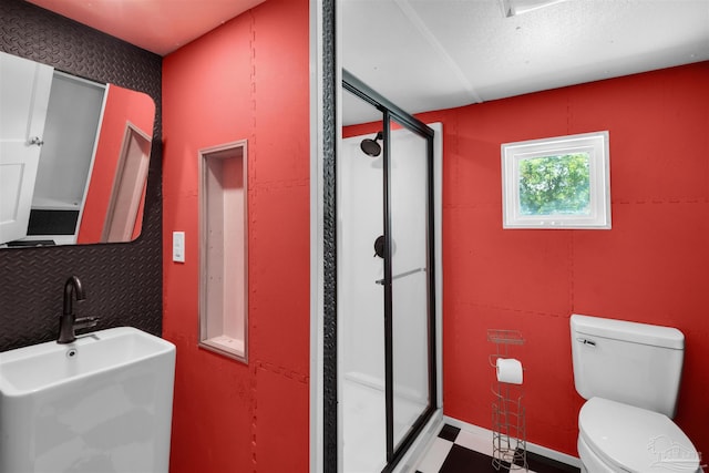 4881 Calvin Dr, Milton, FL 32583 - bathroom featuring a sink, a stall shower, and toilet