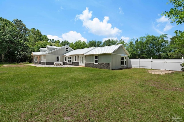 4881 Calvin Dr, Milton, FL 32583 - rear view of property with stone siding, a patio, french doors, and metal roof